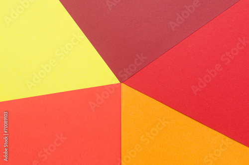 warm-colored construction paper sheets arranged to form a star