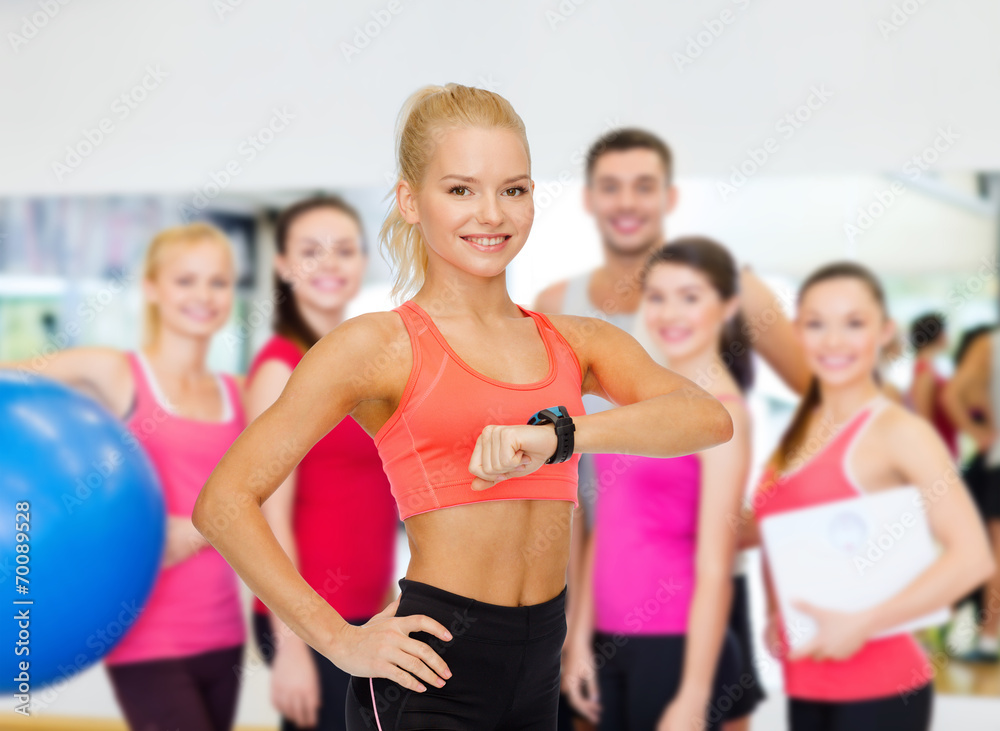smiling woman with heart rate monitor on hand smiling woman with heart rate monitor on hand