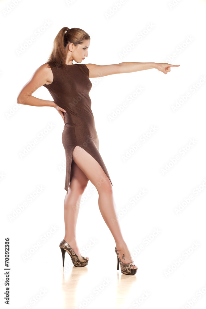 pretty lady in a tight dress showing direction with her finger pretty lady in a tight dress showing direction with her finger
