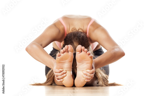 young attractive girl doing yoga exercises photo