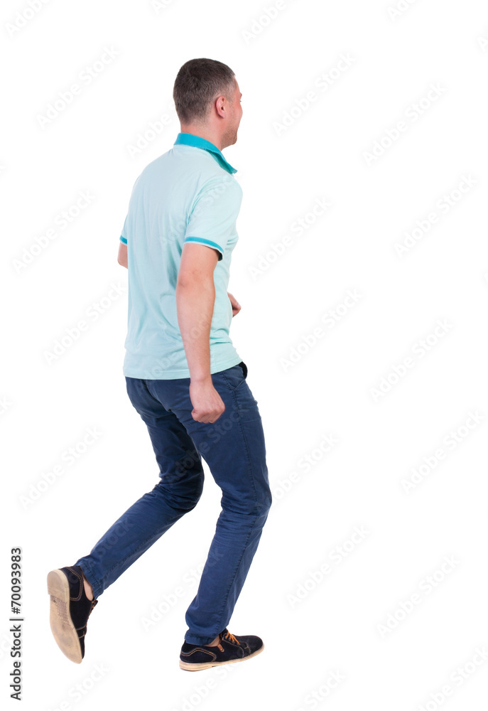Back view of running man in blue polo. Back view of running man in blue polo.
