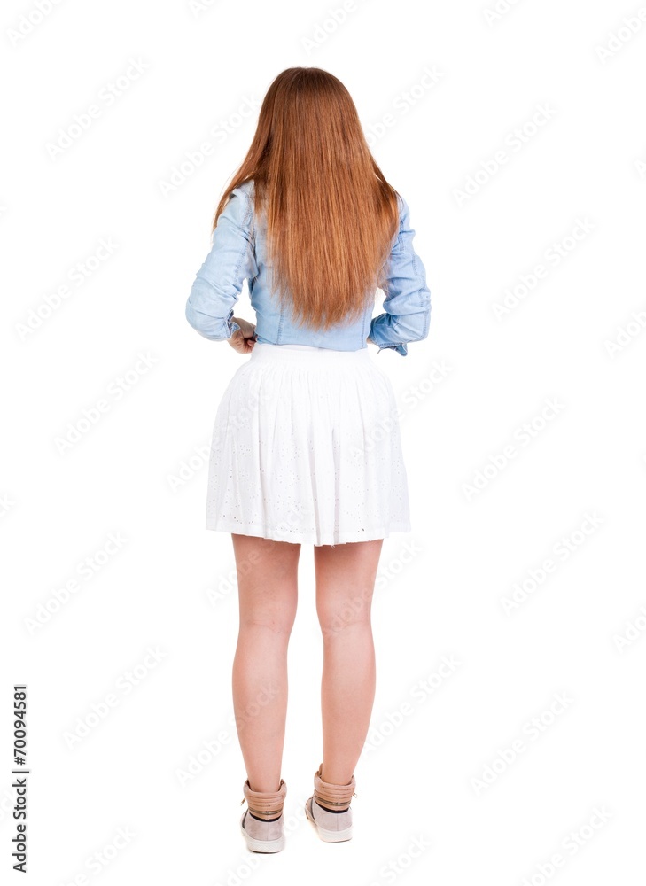 Back view of young redhead woman pointing at wall. Back view of young redhead woman pointing at wall.