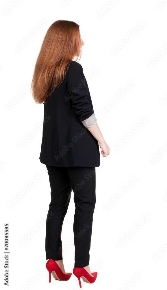 back view of redhead business woman contemplating.