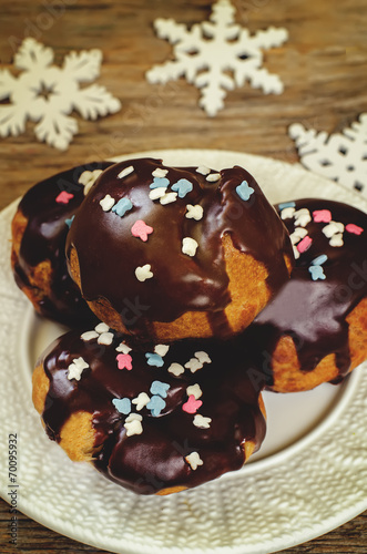 profiteroles with chocolate icing and colored powder