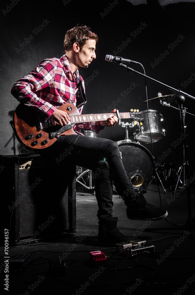 Fototapeta premium Man with guitar during concert