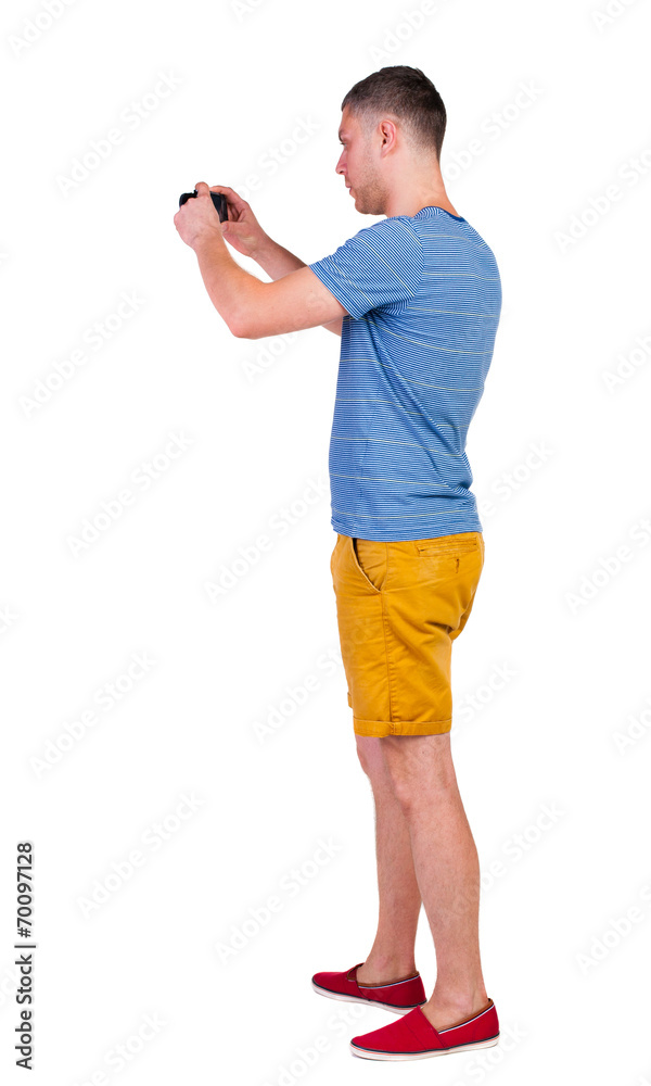 Back view of man photographing. tourist in shorts. Back view of man photographing. tourist in shorts.