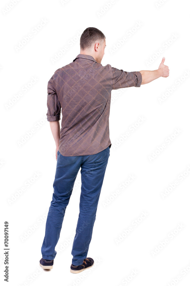 Back view of man in checkered shirt shows thumbs up. Back view of man in checkered shirt shows thumbs up.