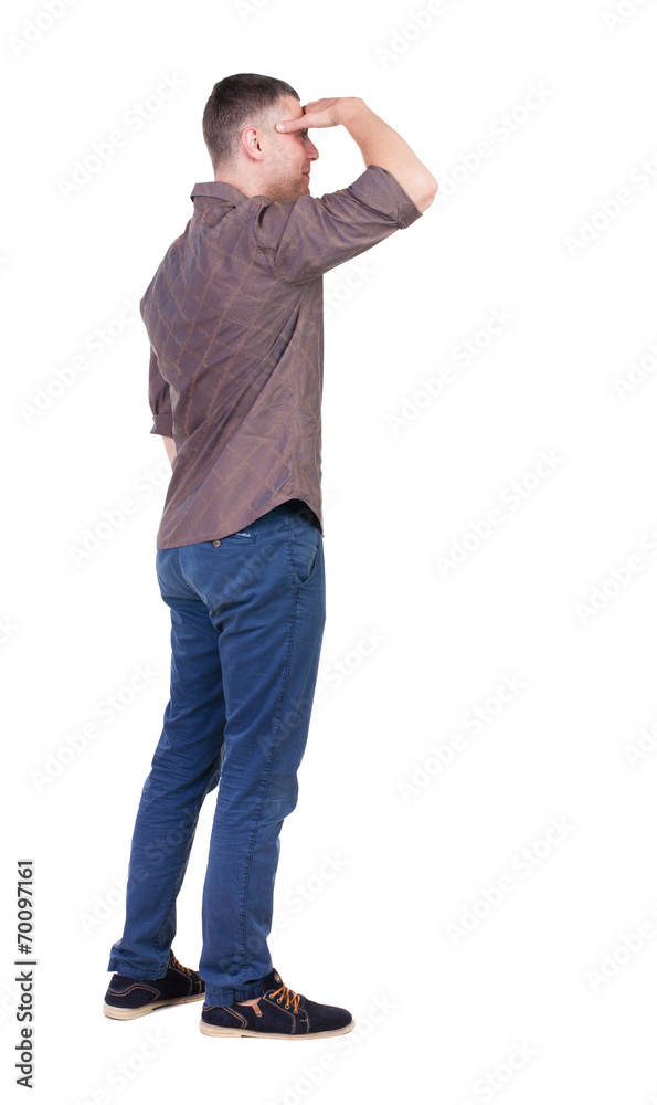 Back view of handsome man in shirt looking up. Back view of handsome man in shirt looking up.