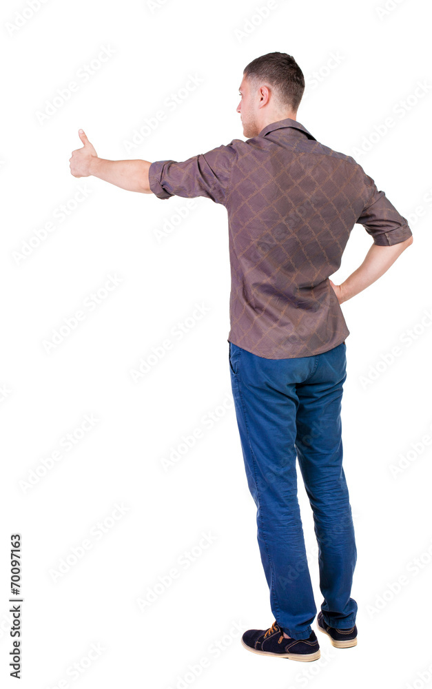 Back view of man in checkered shirt shows thumbs up. Back view of man in checkered shirt shows thumbs up.