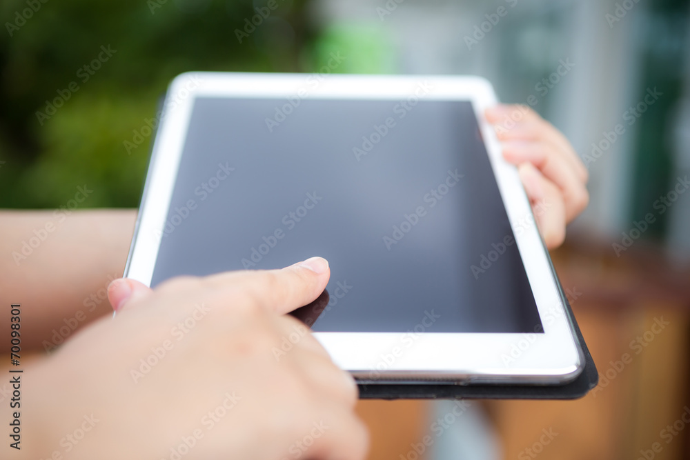 Hand hold white tablet