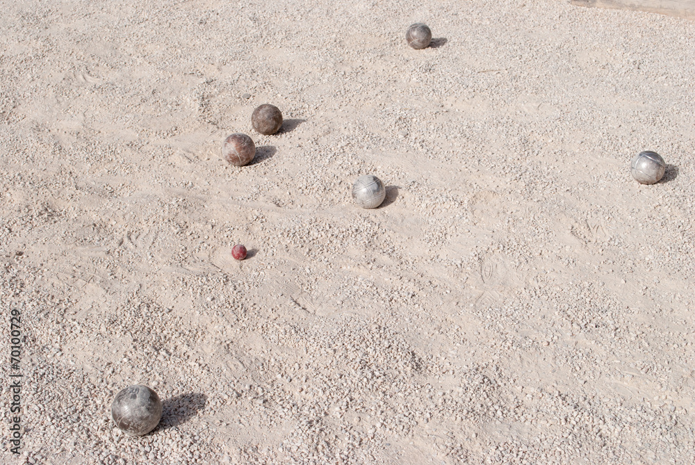 Metallic petanque balls and a small red jack Metallic petanque balls and a small red jack