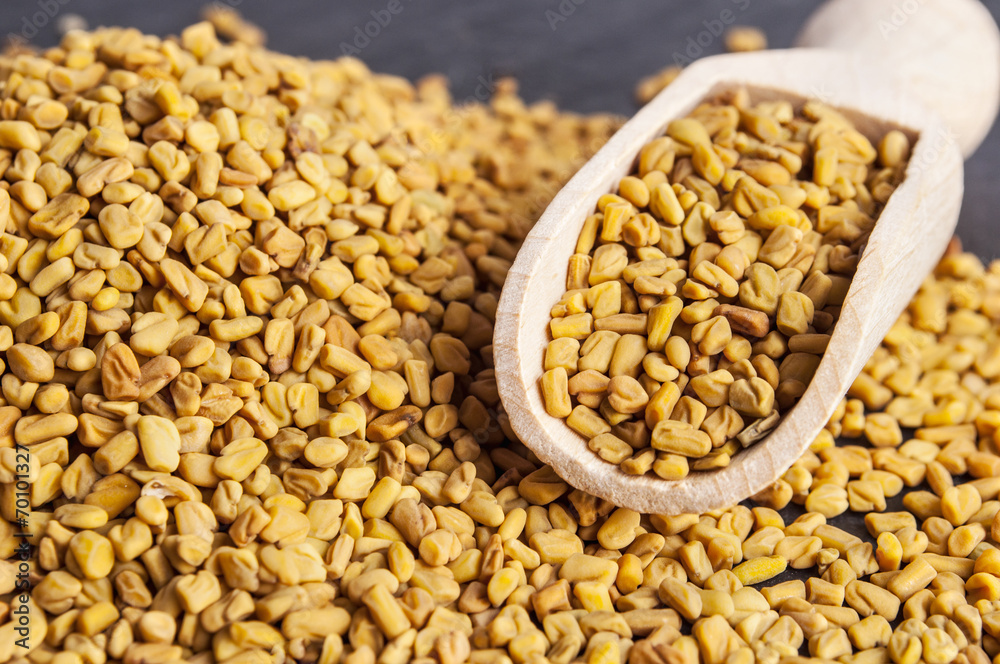 wooden scoop with fenugreek seeds wooden scoop with fenugreek seeds
