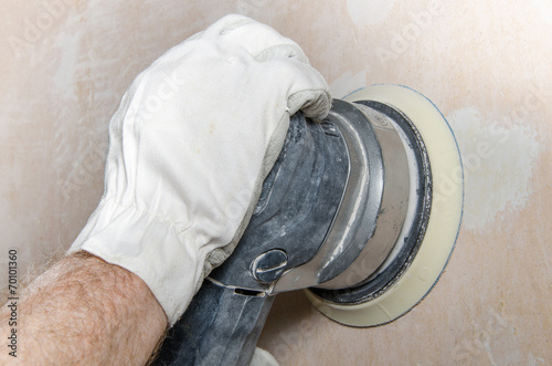 Obraz na plátně Sanding of a wall with a power sander