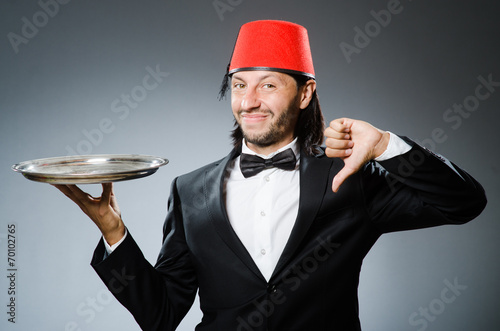 Waiter wearing traditional turkish hat photo