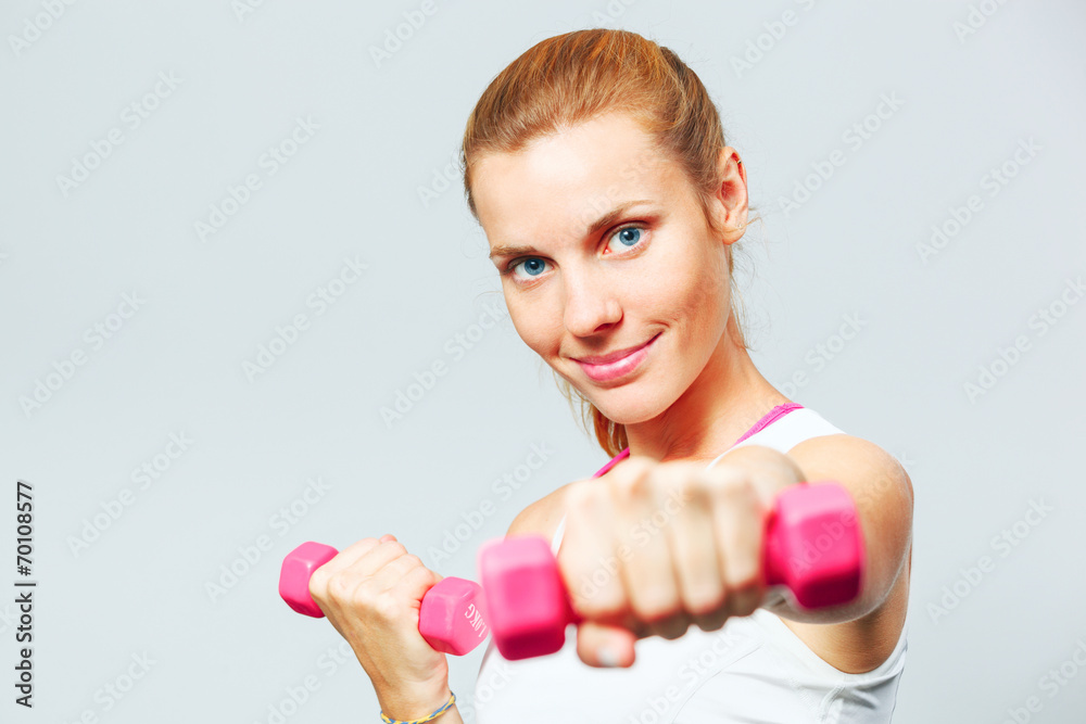 Young woman with dumbbells in her hands. Young woman with dumbbells in her hands.