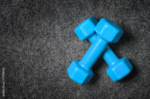 Small dumbbells on floor - fitness concept.