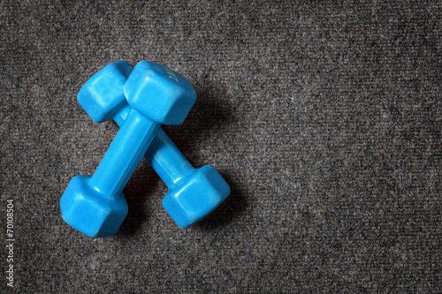 Small dumbbells on floor - fitness concept.