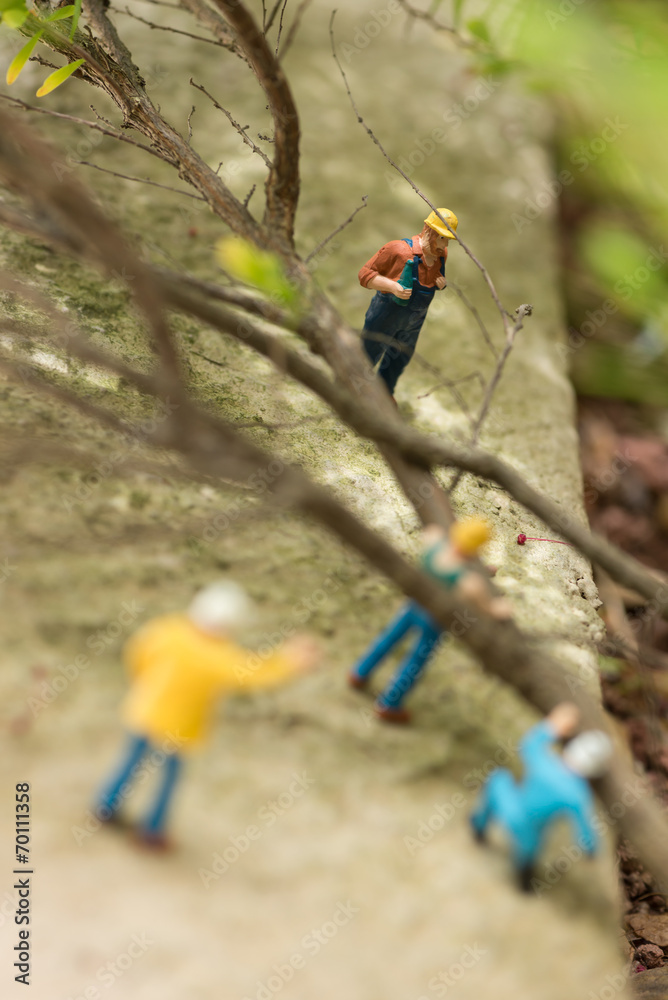 Miniature workmen clearing fallen trees top view Miniature workmen clearing fallen trees top view