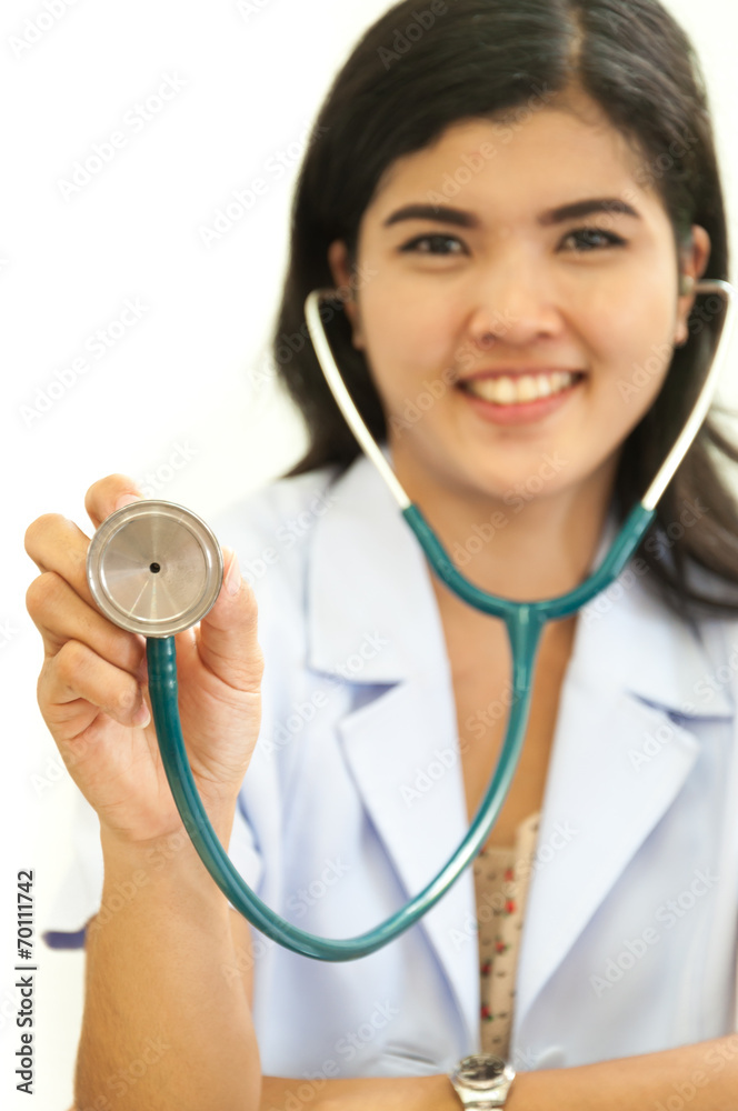 Happy female doctor holding out stethoscope Happy female doctor holding out stethoscope