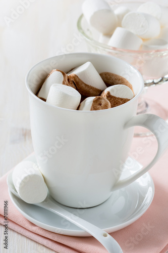 Cup of hot chocolate  with marshmallow on a white table