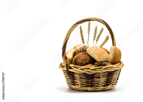 assortment of baked bread in basket on white background