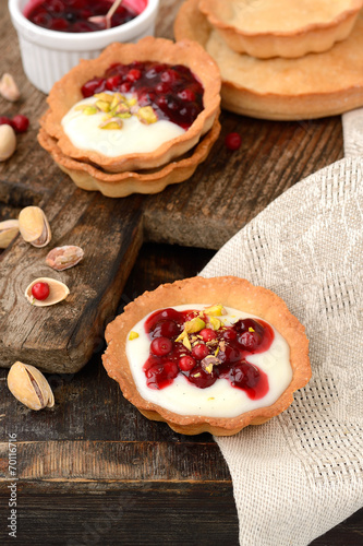 tartlets with cream  berry sauce and pistachios
