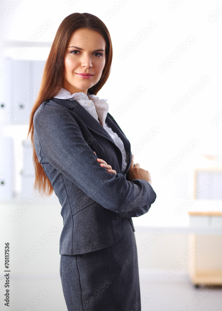 Portrait of business woman standing with crossed arms in office Portrait of business woman standing with crossed arms in office
