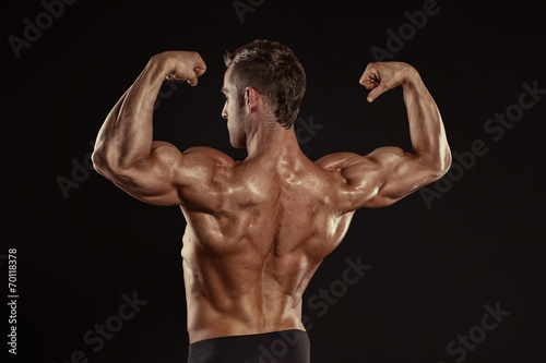 Strong Athletic Man Fitness Model posing back muscles, triceps,