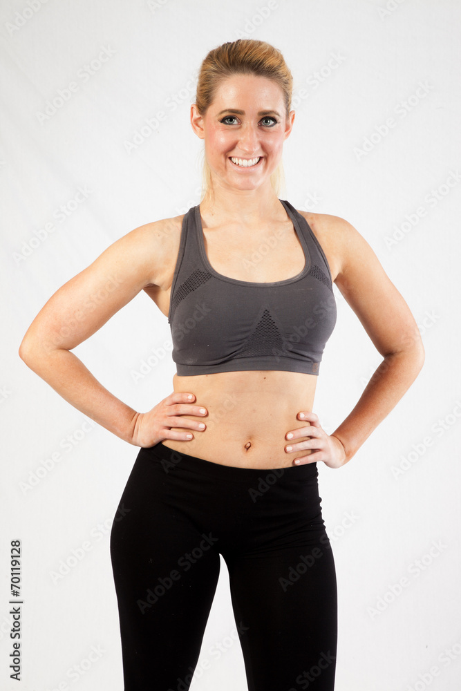 Blond woman in exercise outfit, looking at the camera