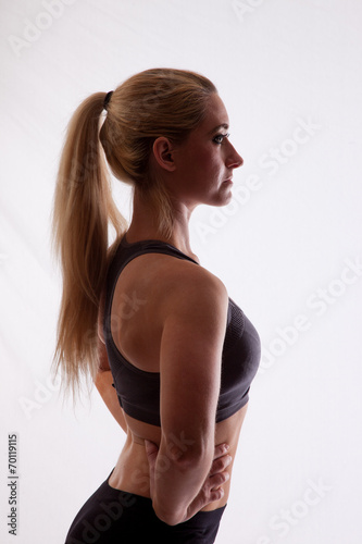 Blond woman in exercise outfit, looking right