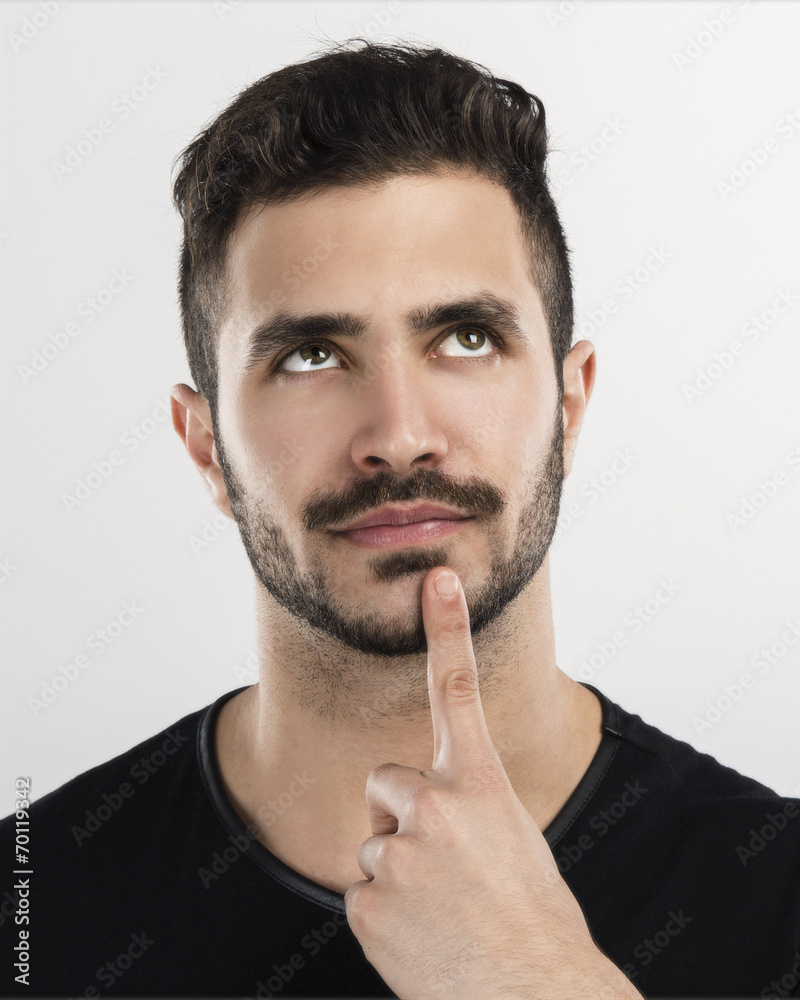 Studio portrait of a handsome young man thinking Studio portrait of a handsome young man thinking