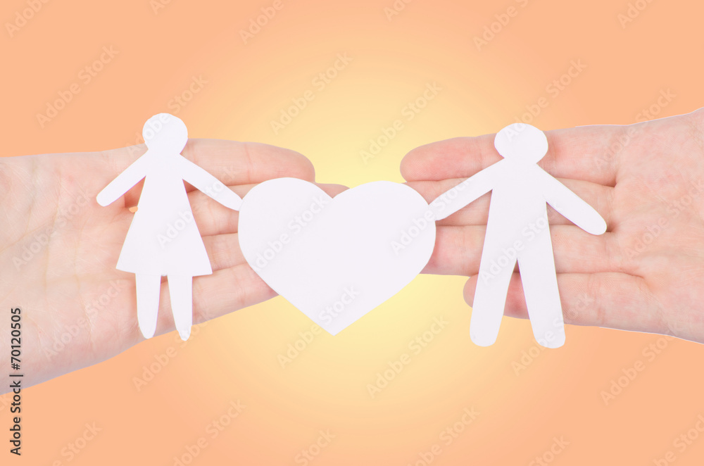 Paper family in hand with a big hearth isolated on white Paper family in hand with a big hearth isolated on white
