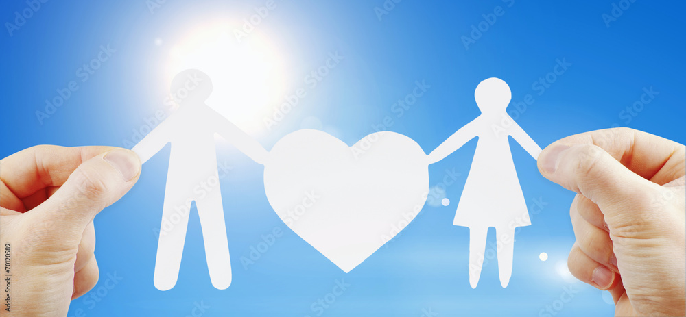 paper family with heart in hands paper family with heart in hands