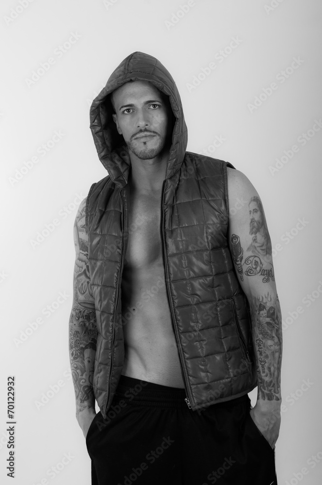 Fototapeta premium Young brunette shirtless male model wearing a vest