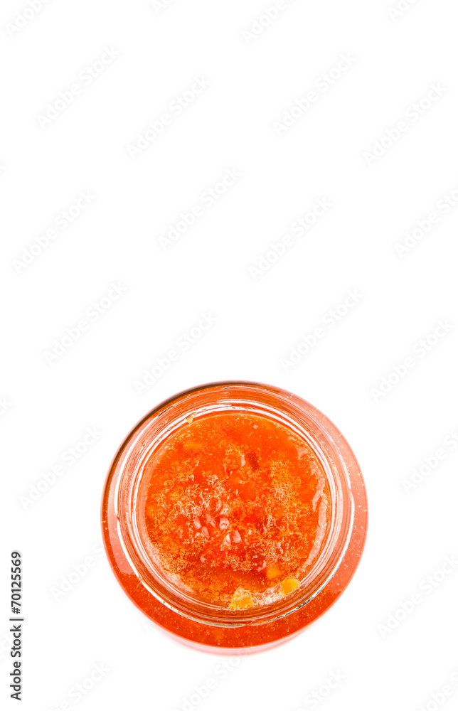Orange fruit jam in a bottle over white background Orange fruit jam in a bottle over white background