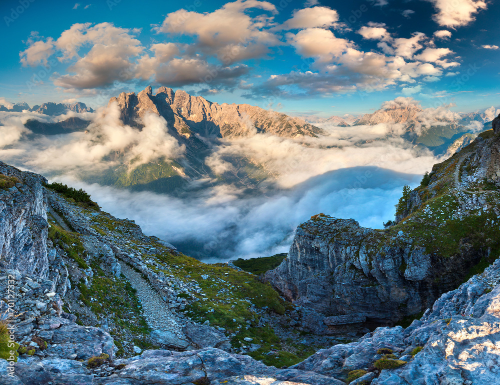 Gruppo Del Cristallo mountain range at foggy summer morning. Dol