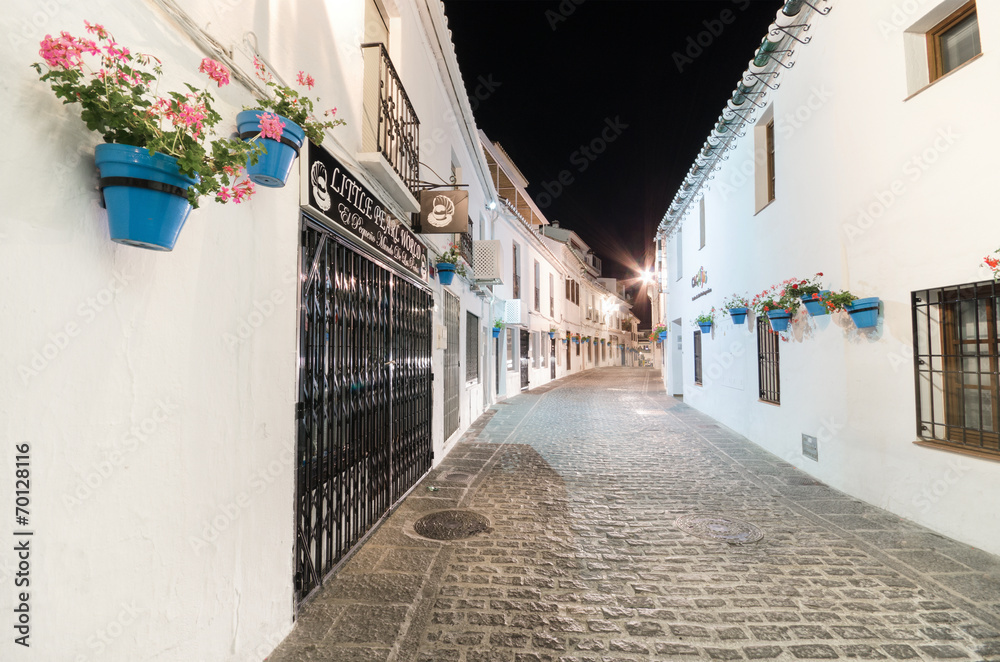 Narrow alley in Mijas village at night, Malaga, Spain.