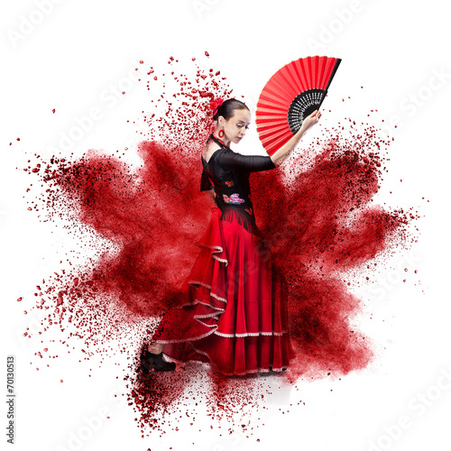 young woman dancing flamenco against explosion