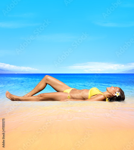 Beach travel Sunbathing woman relaxing under sun