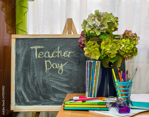 Teacher  Day. Hydrangea flowers and copybooks on the teacher d