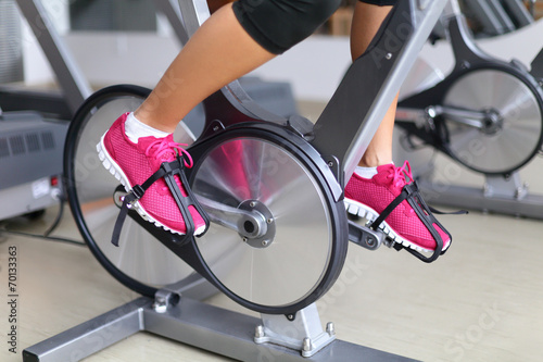 Exercise bike with spinning wheels - woman biking