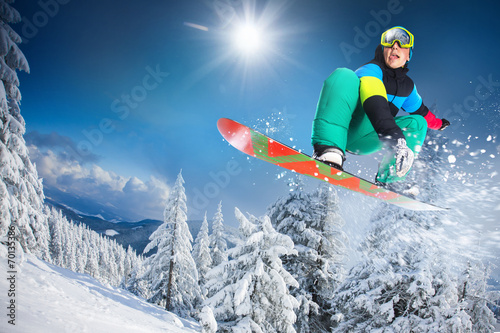 flying snowboarder on mountains