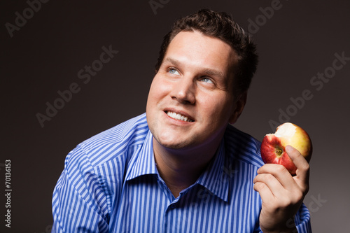 Diet nutrition. Happy man eating apple fruit