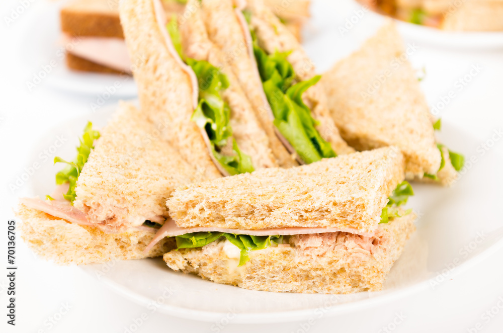 ham and lettuce sandwich on a white plate ham and lettuce sandwich on a white plate