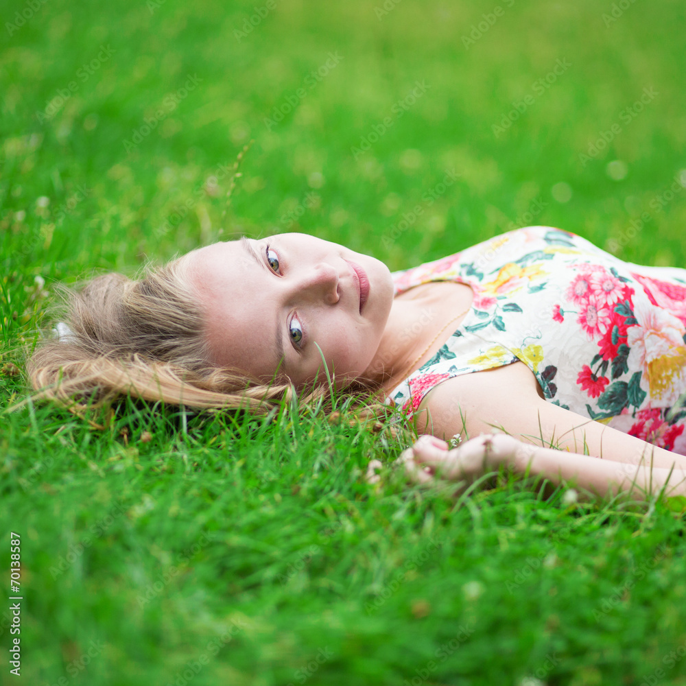 Beautiful young girl lying on the grass Beautiful young girl lying on the grass