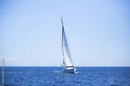 Lonely sailboat in the open sea. Romantic trip.
