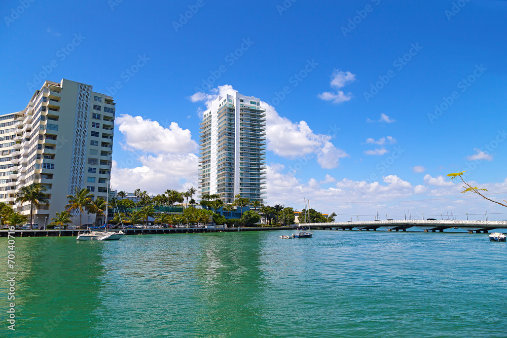 Miami Beach waterfront with anchored yachts near the bridge.