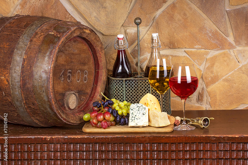 Fototapeta Naklejka Na Ścianę i Meble -  Wine, cheese, grapes and old wooden barrel; still life