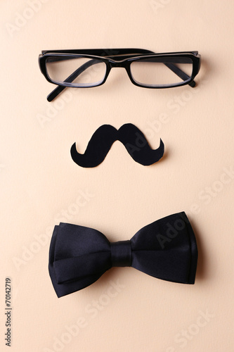 Glasses, mustache and bow tie forming man face