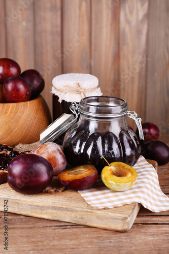 Tasty plum jam in jars and plums